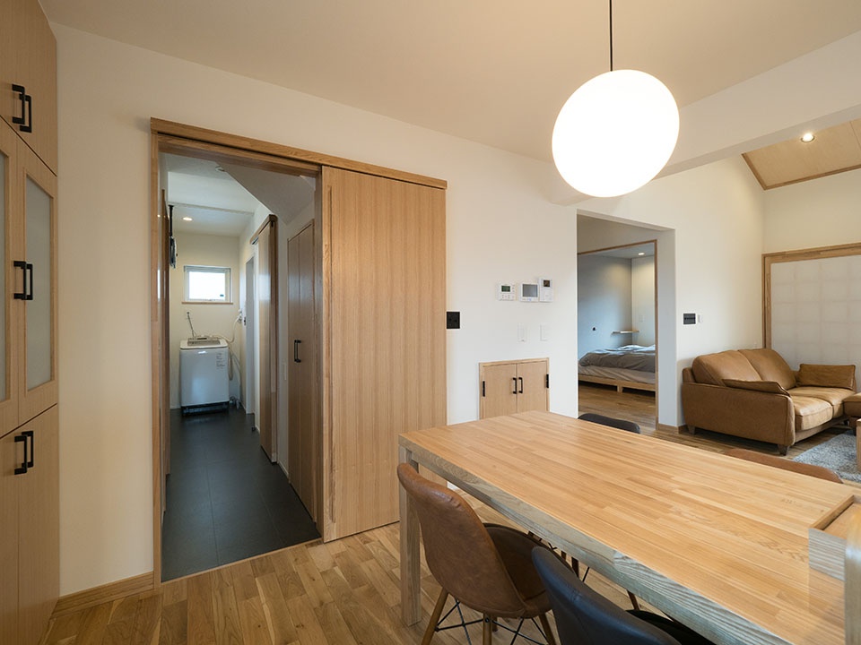 ダイニングからユーティリティー(写真左手奥)、階段室裏のクローゼット、寝室(写真右手奥)と回れる動線